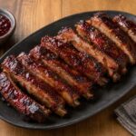 Cherry cola glazed pork spareribs with a glossy caramelized cherry and mustard coating on a serving platter